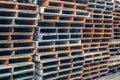 Stacks of old wooden pallets in an industrial yard Royalty Free Stock Photo