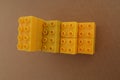 Stacks of one color lego with a brown cardboard background