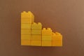 Stacks of one color lego with a brown cardboard background