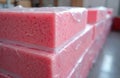Stacks of pink foam insulation panels wrapped in plastic. Material for building, home renovation, and energy efficiency projects. Royalty Free Stock Photo