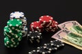 Stacks of poker chips and dollar bills on black background. Poker concept, chips and money Royalty Free Stock Photo