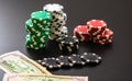 Stacks of poker chips and dollar bills on black background. Poker concept, chips and money Royalty Free Stock Photo