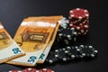 Stacks of poker chips and EURO bills on black background. Poker concept, chips and money Royalty Free Stock Photo