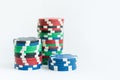 Stacks of poker chips including red, black, white, green and blue on a white background Royalty Free Stock Photo