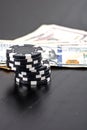 Stacks of poker chips with money on black background Royalty Free Stock Photo