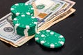 Stacks of poker chips with money on black background Royalty Free Stock Photo