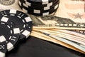 Stacks of poker chips with money on black background Royalty Free Stock Photo