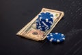 Stacks of poker chips with money on black background Royalty Free Stock Photo