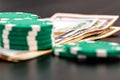 Stacks of poker chips with money on black background Royalty Free Stock Photo