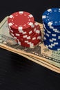 Stacks of poker chips with money on black background Royalty Free Stock Photo