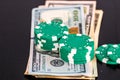 Stacks of poker chips with money on black background Royalty Free Stock Photo