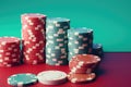 Stacks of poker chips on red and green background. Casino concept, casino chips on isolated pastel background, AI Generated Royalty Free Stock Photo