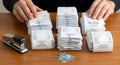 Stacks of printed receipts organized on wooden desk with paperclips and stapler Royalty Free Stock Photo