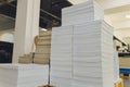 Stacks of printed sheets of cardboard on wooden pallets closeup. printing industry.