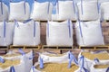 Stacks of raffia large sand sacks stacked over wooden pallets wi