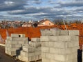 Stacks of red bricks and concrete blocks at construction supply yard. Building materials, industry, development, housing Royalty Free Stock Photo