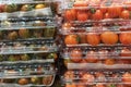 Stacks of red cherry tomatoes in plastic containers close-up in a supermarket. Royalty Free Stock Photo