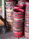 Stacks of red and natural wood slat baskets with handles