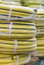 stacks of rolls yellow pvc plastic pipe on the counter in the store. Sale Hoses in the garden of various manufacturers, on shelves