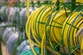 stacks of rolls yellow pvc plastic pipe on the counter in the store. Sale Hoses in the garden of various manufacturers, on shelves Royalty Free Stock Photo