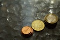 Stacks of shiny euro coins on a glass table