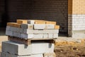 Stacks of silicate bricks on wooden pallets and in polyethylene