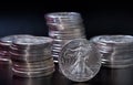 Stacks of silver coins with one upright in front Royalty Free Stock Photo