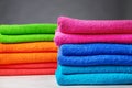 Stacks of soft color towels on table, closeup