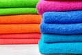 Stacks of soft color towels on table, closeup