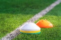 Stacks of Sport marker on training pitch with green field and white boundry line Royalty Free Stock Photo