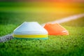 Sport marker cone on training pitch with green field and white boundry line Royalty Free Stock Photo