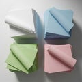 Square sheets are arranged in four piles, each a different color white, blue Royalty Free Stock Photo
