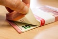 Stacks of ten Euro bills on a pine desk, being counted Royalty Free Stock Photo