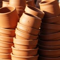 Stacks of terracotta pots in various sizes, with a smooth finish, are closely arranged. Royalty Free Stock Photo