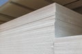 Stacks of thick expanded polystyrene sheets in a building materials warehouse or store.