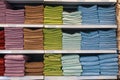 Stacks of towels on a store shelf. Showcase with textiles for personal hygiene