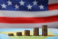 Stacks of USA cents on map against flag Royalty Free Stock Photo