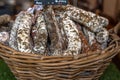 Stacks of various kinds of saucisson or saucisson sec - dry-cured sausages. Royalty Free Stock Photo