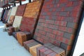 Stacks of various and for sale. Building colorful construction materials, colored concrete pavers (paving stone)