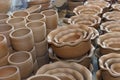 Stacks of various terracotta pots for plants.