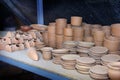 Stacks of various terracotta pots for plants.