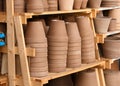 Stacks of various terracotta pots for plants for sale at a garden store