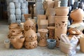 Stacks of various terracotta pots for plants.