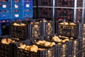 Stacks of vegetable boxes with freshly potatoes in storage warehouse at vegetable factory