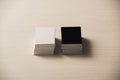 stacks of white and black empty business cards on white wooden surface. Royalty Free Stock Photo