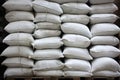 Stacks of white cement bags in warehouse