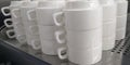 Stacks of white cups of three pieces Royalty Free Stock Photo