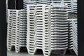 Stacks of white plastic chaise-lounge beach beds Royalty Free Stock Photo