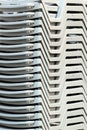 Stacks of white plastic chaise-lounge beach beds Royalty Free Stock Photo
