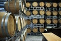 stacks of wine barrels on metal crates organized on top of one another